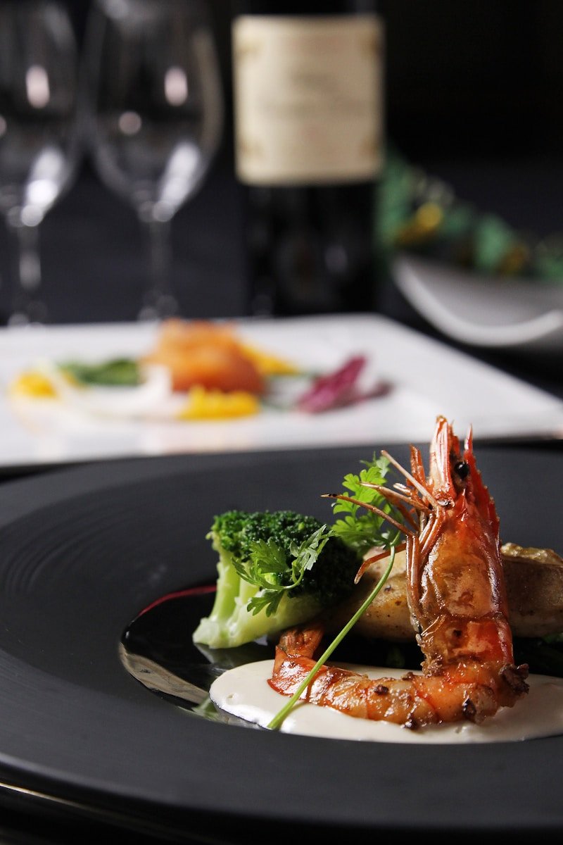 Elegant dinner plate with shrimp and vegetables.