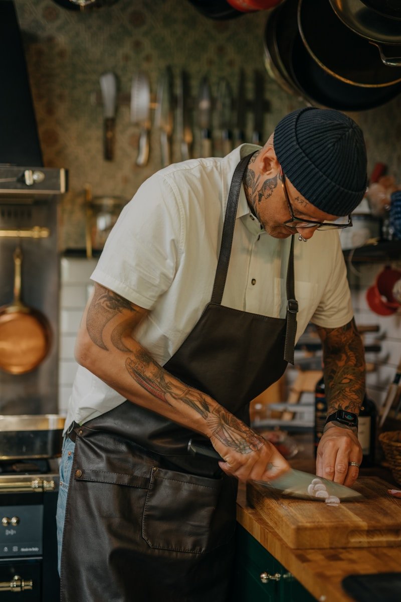 Photo by 🇸🇮 Janko Ferlič a man with tattoos holding a knife