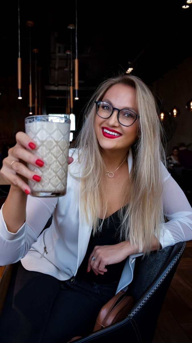 Photo by Наталья Кленова woman in white blazer holding white and red ceramic mug